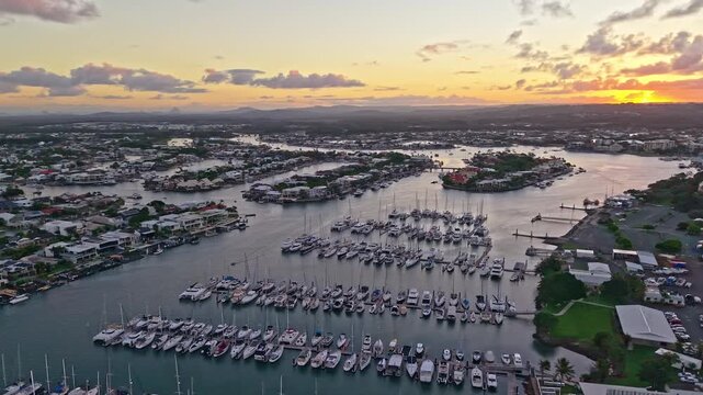 Aerial sunset over Mooloolaba Harbour marina and river channels, Sunshine Coast Queensland