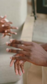 Vertical video: Recording starting woman wearing white top and jeans speaking into mic in studio