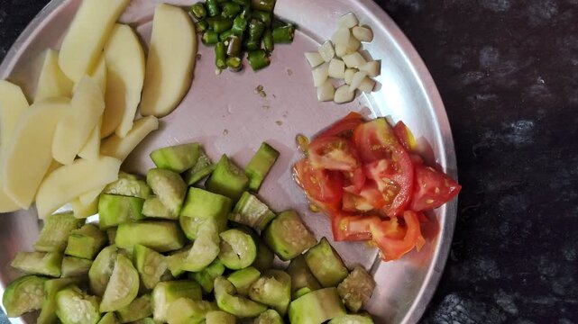 Fresh Ingredients Ready for Cooking Chopped Turai, Potato, and Tomato Platter
