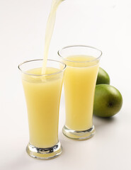 Fototapeta premium Aam Panna is a traditional Indian summer drink made primarily from boiled or roasted raw mangoes (kairi), blended with sweeteners, herbs, and spices. It is renowned for its tangy and sweet taste