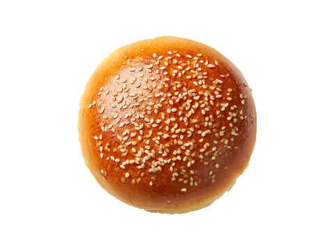 Deliciously golden brown hamburger bun topped with sesame seeds seen from above on transparent background