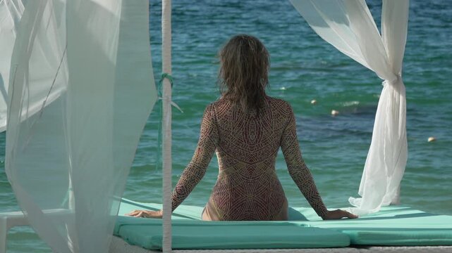 Serene Luxury Tropical Woman Relaxes in Private Beach Cabana Vertical video