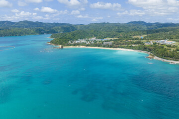 Obraz premium Aerial view of emerald green Oura Bay and coastline near Setake lighthouse ruins in Nago, Okinawa