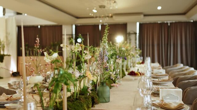 Event setup with flowers and decorations in a banquet hall for a gathering