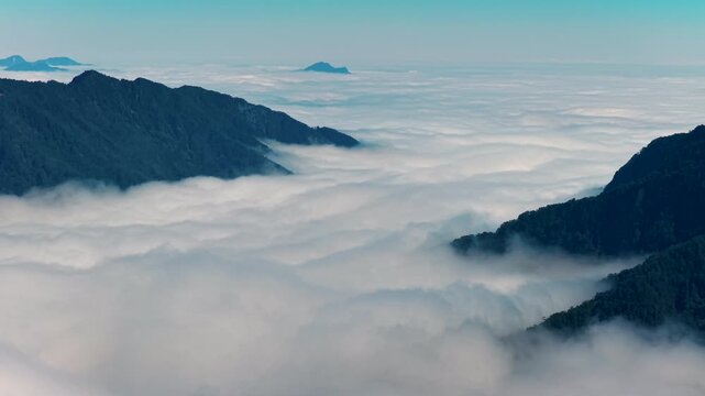 Aerial view above the sea of ​​clouds with the sunset