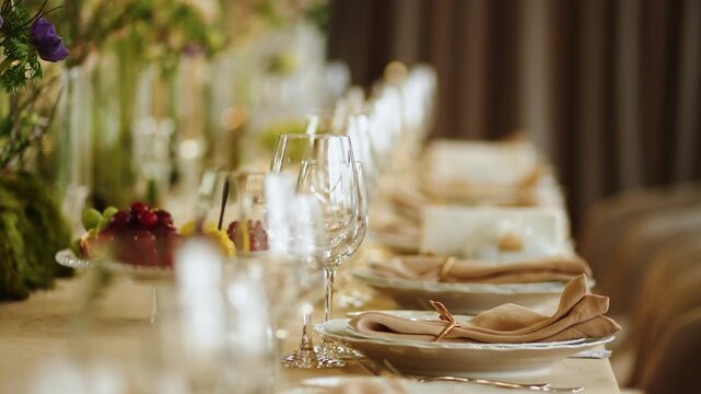 Elegant dining setup with wine glasses and utensils at a restaurant in the early evening