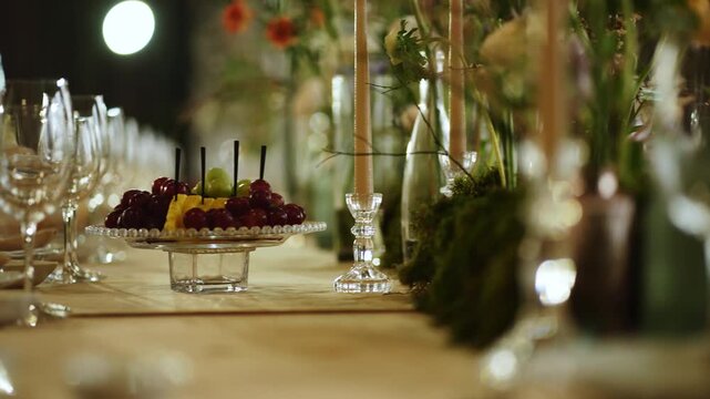 Elegant table setup for a gathering with flowers and glassware in the evening