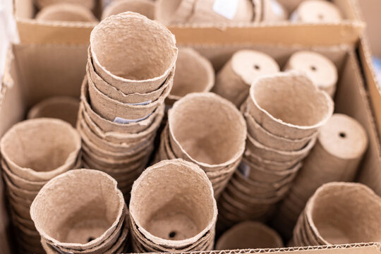Biodegradable seedling pots paper pulp on wooden table ideal for flowerpot garden balcony ,seeding plant cultivation.