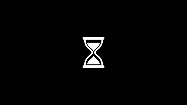 A close-up view of an hourglass on a plain surface indoors.