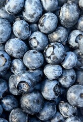 Top view macro of fresh blueberries with waxy bloom and water drops background pattern © Марія Мешко