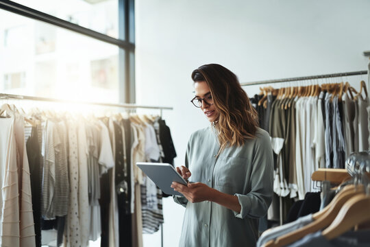 Small business owner using AI software to track inventory and sales analytics in a retail shop