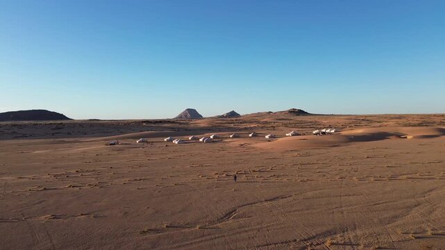 Aerial drone view of Ben Amera monolith with desert camp in Mauritania, Sahara landscape