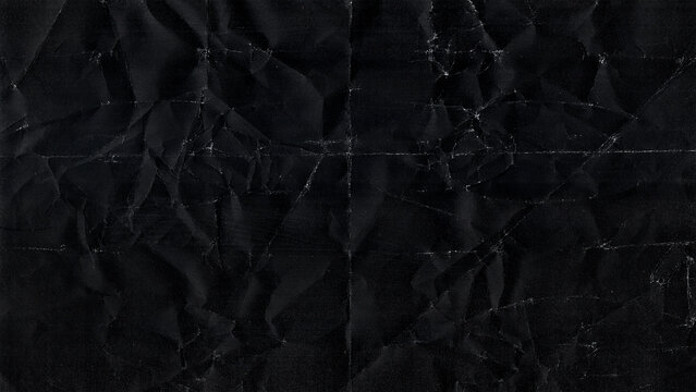 Black crumpled paper texture with fold lines dark grunge background