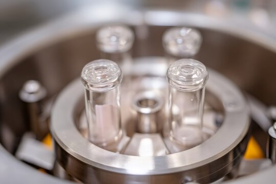 Close-up of glass vials in a laboratory centrifuge rotor. Scientific equipment for medical research and chemical analysis. Modern technology in the pharmaceutical industry