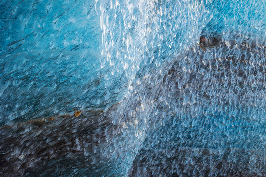 View of the intricate textures and deep blue hues of the Svinafellsjokull glacier ice Sveitarfelagid Hornaf, Iceland.