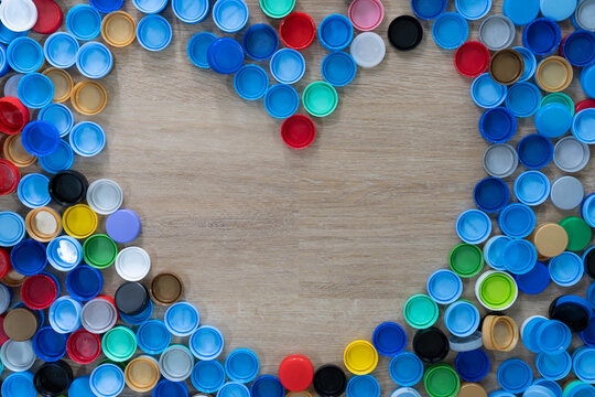 Close up plastic bottles caps for recycling to conserve the environment, recycling, reuse, garbage disposal, save the world concept., heart shape