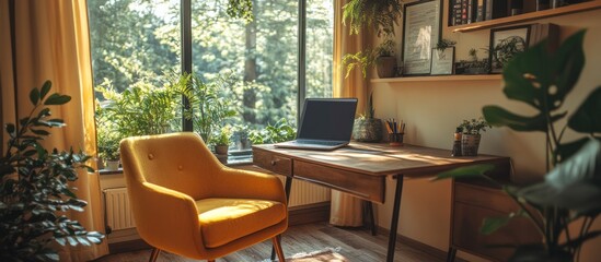 Fototapeta premium A cozy home office with a yellow chair, a desk with a laptop, and a large window overlooking a green forest.