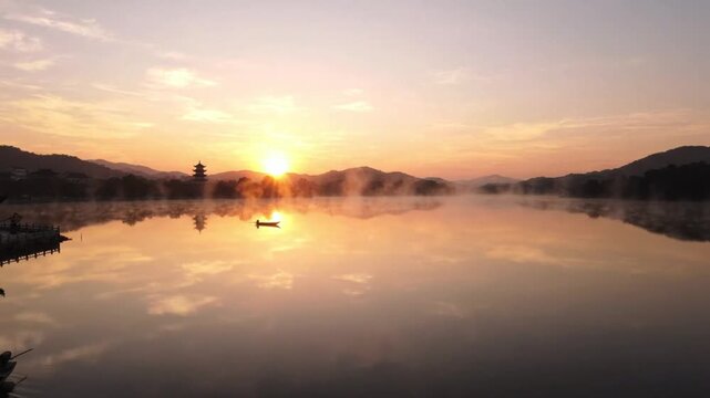 Ultra wide drone shot of West Lake sunrise calm water tiny boat luxury banner 4K