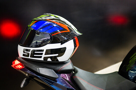 Close-up of stylish motorcycle helmet on dark bike