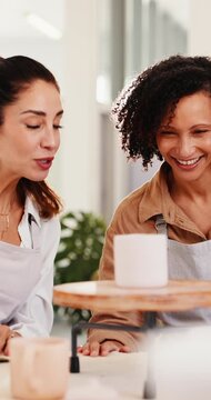 Women, smile and high five in pottery class with mug design approval, teacher or success for project. Mature people, potter and support in workshop with celebration, ceramic cup or well done for art.