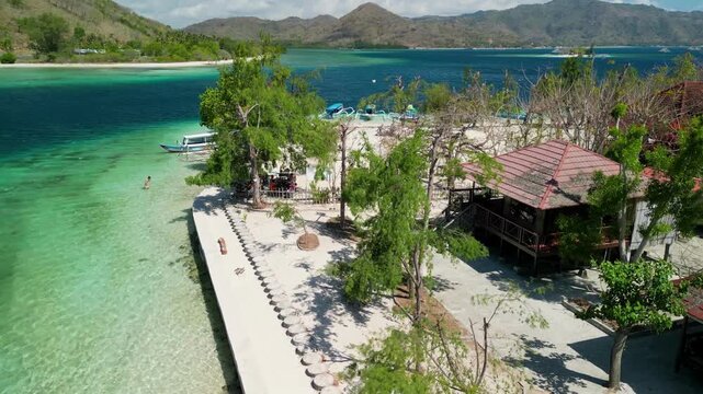Aerial drone view Gili Sudak Lombok Indonesia on sunny day with white sand beach turquoise lagoon and tropical island paradise