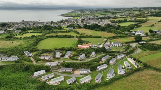 Aerial View of Caravan Park With Coastal Town and Sea in Distance on Anglesey Wales