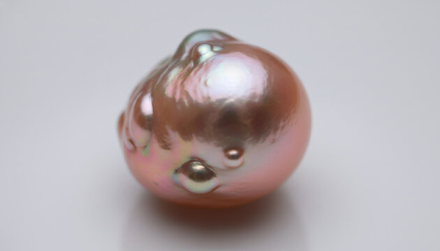 Natural Baroque pearl nacre texture with iridescent pink and green reflection
