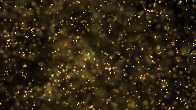 Dark background with luminous golden particles scattering outward in bright explosion captured in dynamic festive burst moment