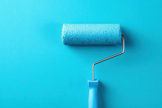 Using a paint roller on a smooth blue surface to apply fresh paint at a home improvement project