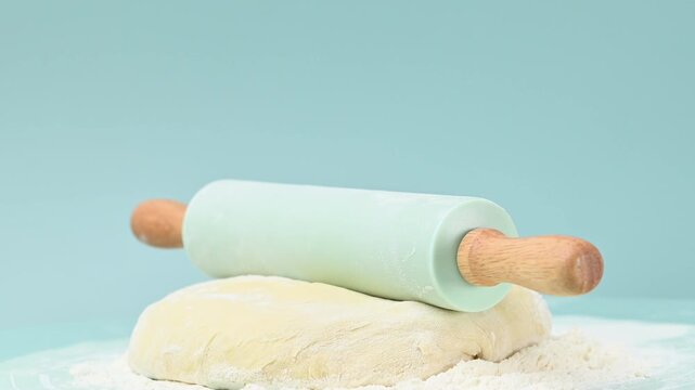 rolling pin and dough on a table