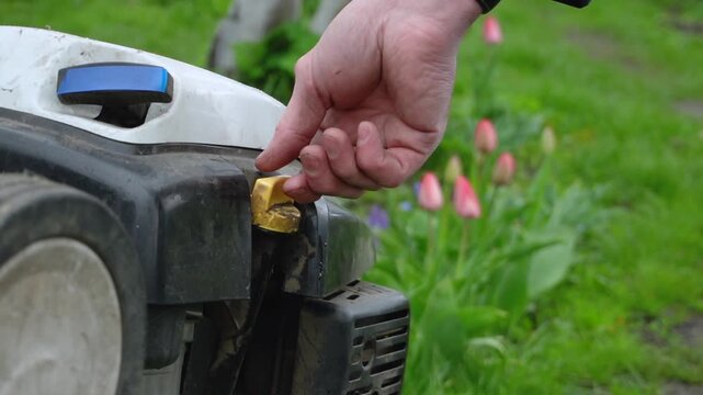Checking the oil level in the cultivator with a dipstick