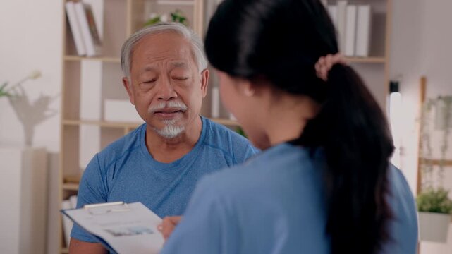 Senior man nurse home care caregiving healthcare consultation medical checkup, elderly patient listening and talking during supportive living room visit, caregiver providing comfort and concern