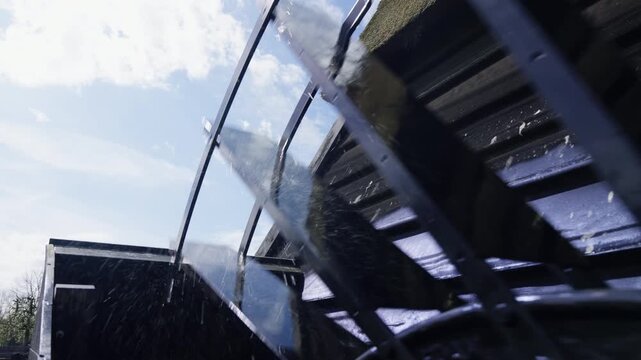 Industrial Water Wheel Movement Under Sunny Sky