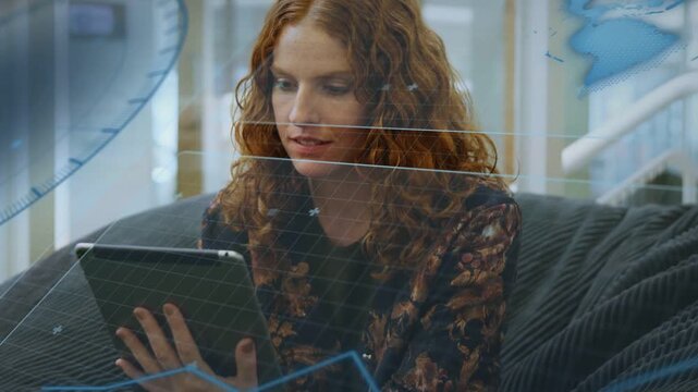 Woman tapping tablet on lounge seat, initiating HUD overlays, analyzing tech and laughing