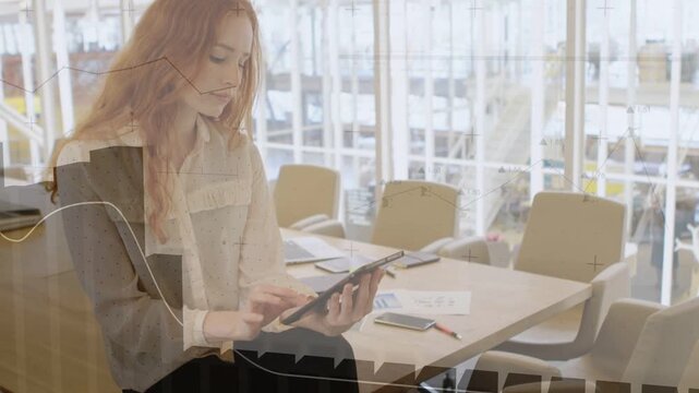 Woman sitting meeting table edge tapping tablet and initiating overlay showing charts for analytics