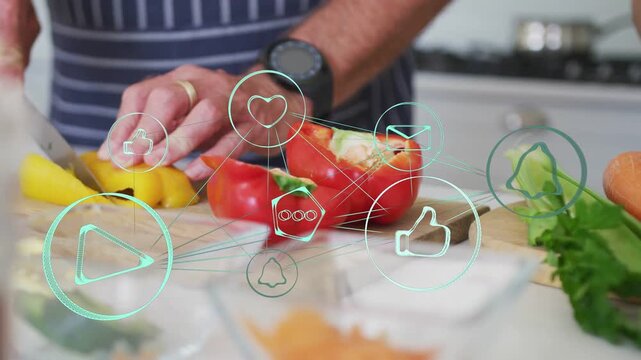 Man grabbing knife and slicing yellow bell pepper on board, social icons overlaying for cooking