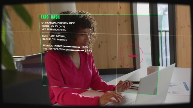 Woman typing at laptop, EXEC DASH HUD animating and moving with her, reviewing Q4 finance charts