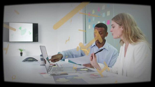 Male coworker pointing at laptop starting yellow overlay growing while team reading business papers