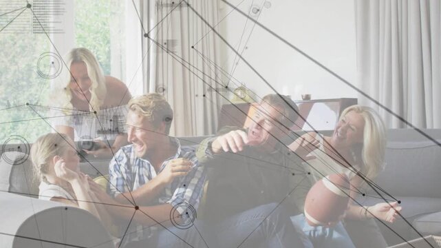 Senior female holding football, family playing tussling highfiving on couch tech HUD animating