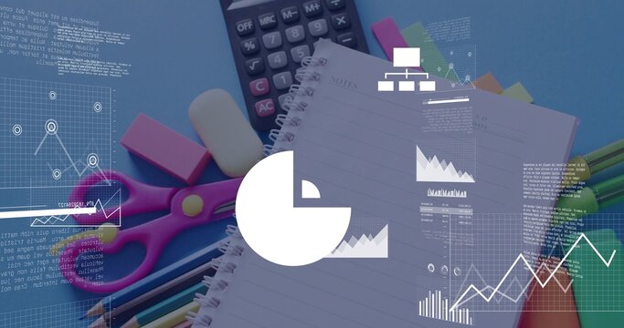 Showing spiral notebook on blue desk with calculator, pink scissors, pencils, pens, digital charts