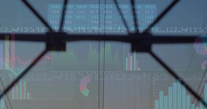 Projecting financial charts across glass panes with X-shaped brace at atrium, with numeric grid