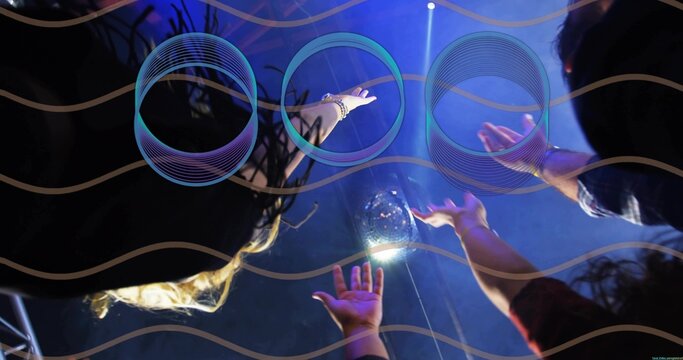 Reaching crowd extending arms toward suspended orb at club stage with blue purple lights, bracelets