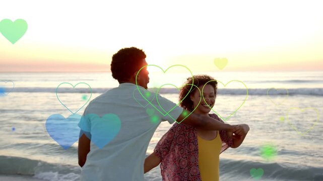 Couple holding twirling at sunset, man closing in as hearts floating over couple for travel content