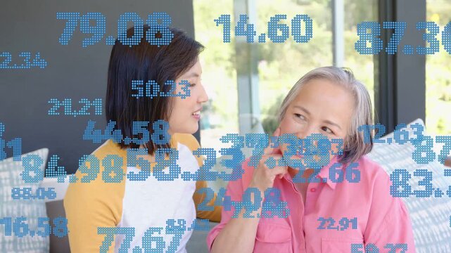 Mother speaking daughter reaching kissing embracing on sofa health care with blue digits overlaying