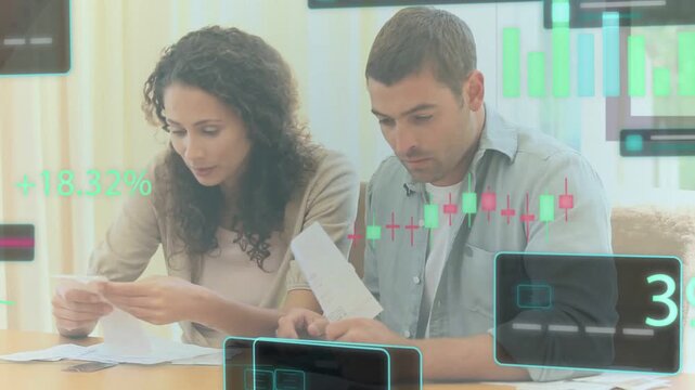 Woman pointing bill, man joining, sorting bills while finance candlestick overlays floating +18