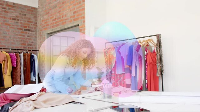 Fashion pro examining patterns, smoothing, marking for samples as soft overlay showing over tablet