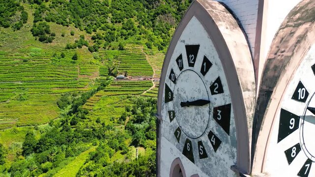 Iconic white clock tower of Chapel of Our Lady of Fatima standing proudly atop Pico da Cova peak in Sao Vicente Madeira