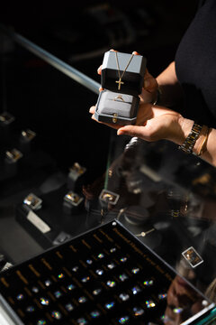 Luxury jewelry box with ring and necklace in elegant boutique setting.