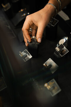 Customer selects a ring from a jewelry display in a retail store environment.