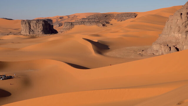 A trip to Sahara desert in Algeria. Beautiful 
african travel photo. Sandy landscapes, mountains, rocks,
dunes, and nature. Summer vacation in arab country.